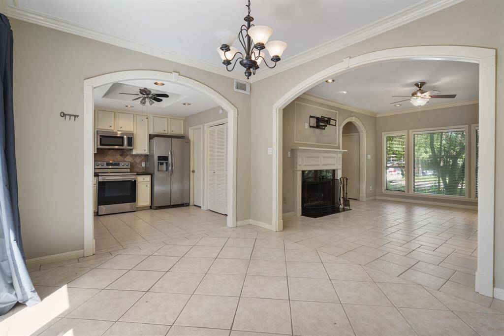 The dining room has crown molding and beautiful archways.