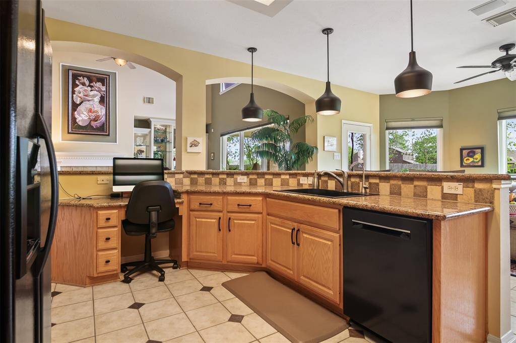 The kitchen has built in desk area with drawers and overlooks the family room. Bosch dishwasher replaced in 2020.
