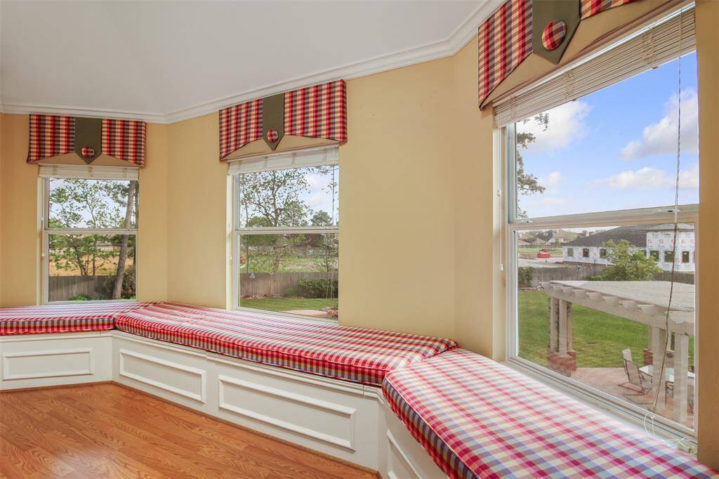 The gameroom also features a bay window with built in seating and storage overlooking the backyard.