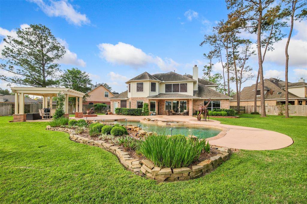 This backyard is perfect for entertaining. There is plenty of grass area to play and a large swimming pool and patio area.