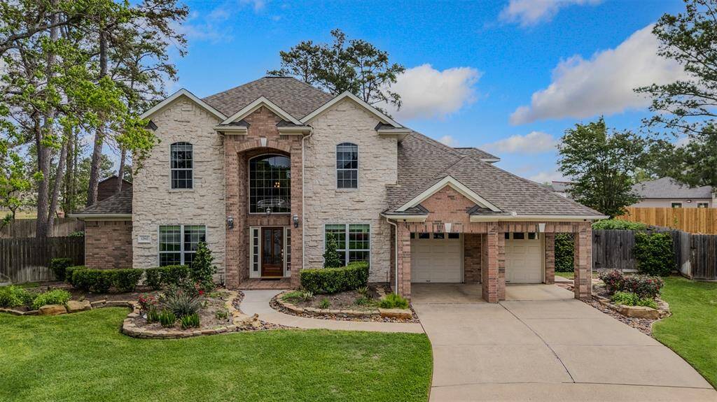 Beautiful front elevation with brick and stone highlights by Emerald Homes.