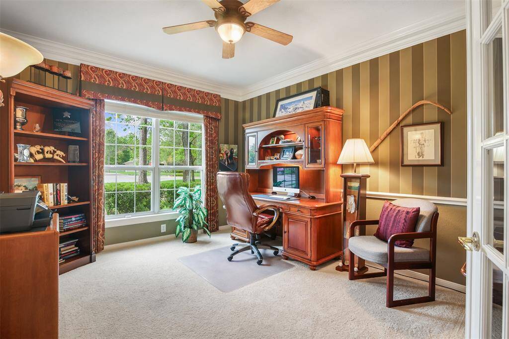 The study is just off the front entry with carpet, large picture windows and chair rail. Carpet replaced in the last five years.