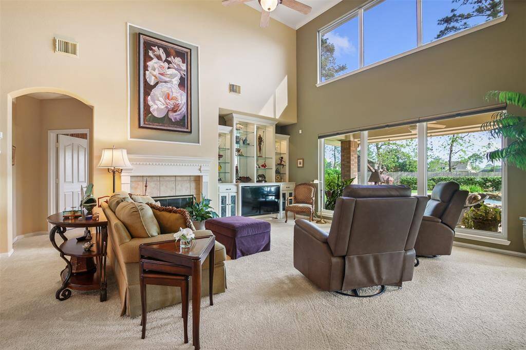 Family room has two story ceilings and picture windows overlooking the backyard oasis with lots of natural light.