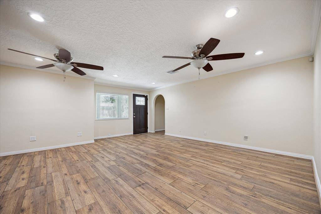 Open concept living / dining with wood look tile floors throughout