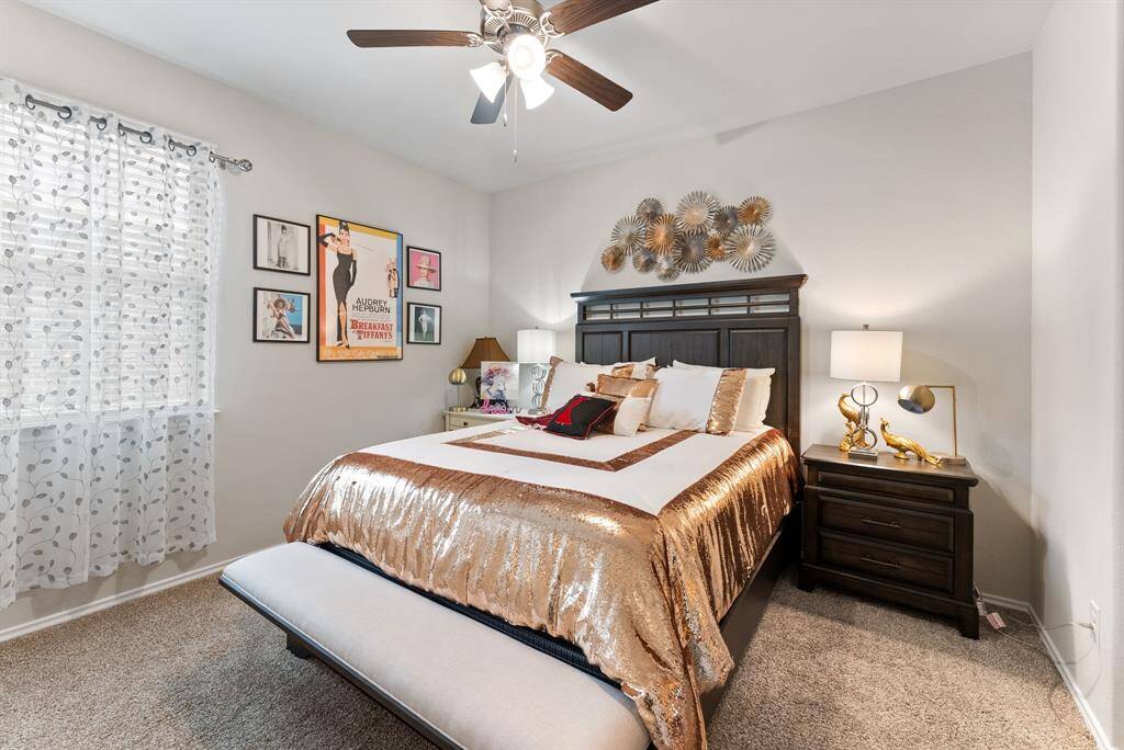 The third secondary bedroom features neutral paint, soft carpeting, and a ceiling fan