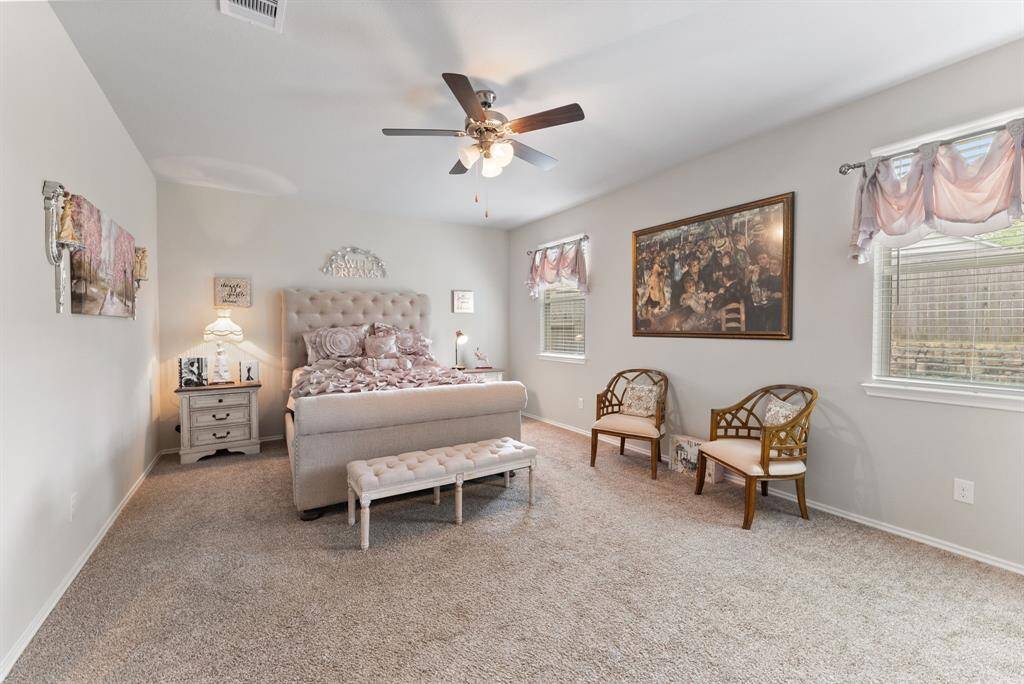 The spacious primary bedroom offers a serene retreat with its expansive layout