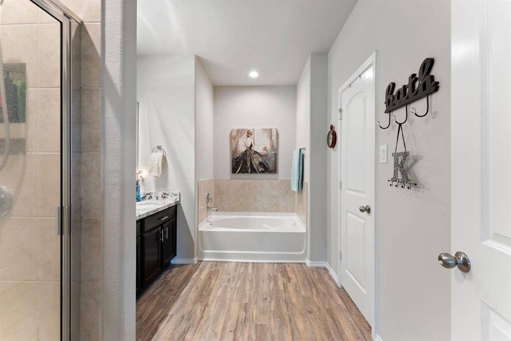 The spacious primary bathroom features a large walk-in closet accessible through a door on the right side