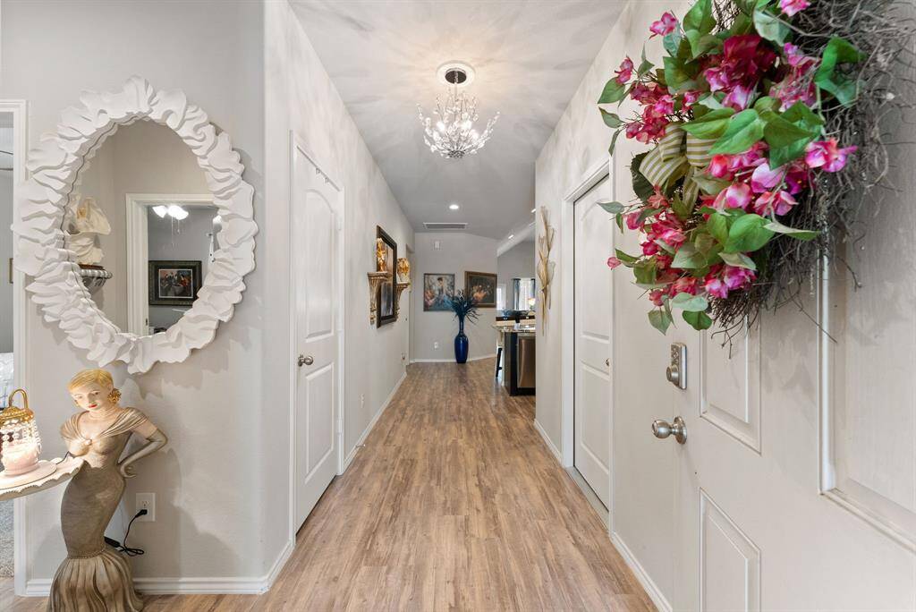 As you enter this home, you'll find two cozy bedrooms to the left and convenient access to the garage on the right.
