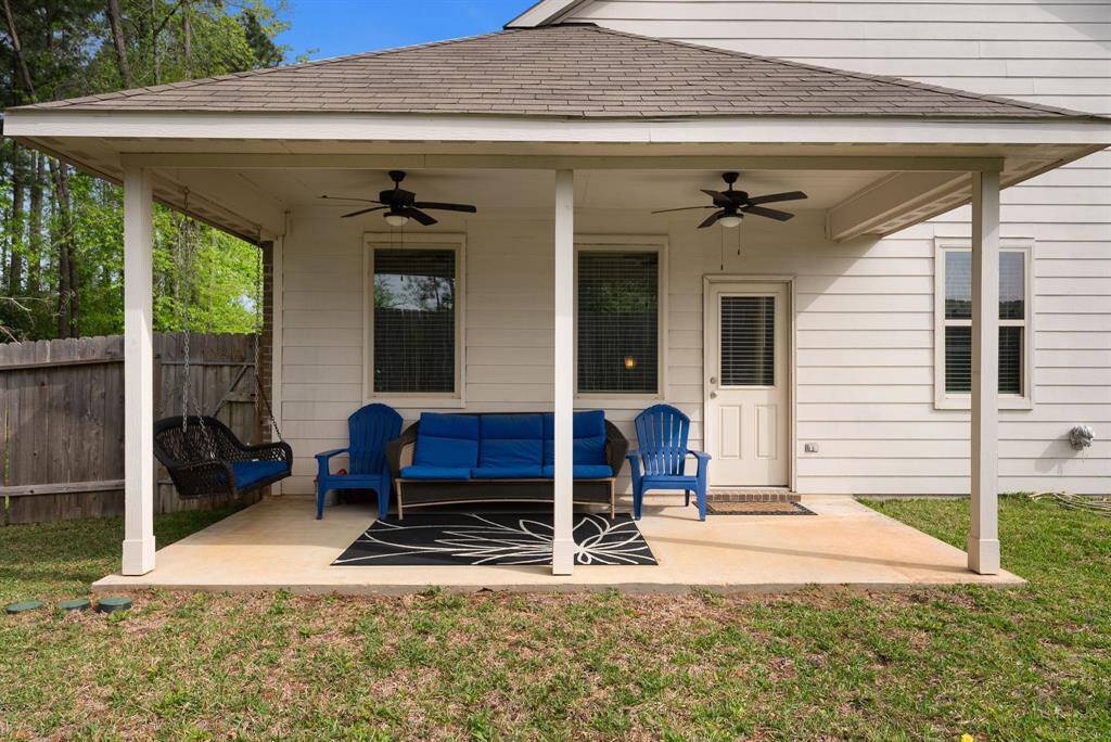 The back covered patio offers a serene outdoor retreat, providing ample space for relaxation and gatherings, all while being sheltered from the elements.