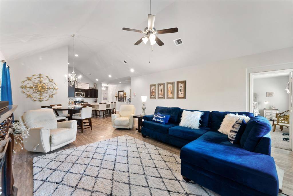 The spacious living room seamlessly flows into the kitchen area, with the primary bedroom conveniently situated to the right