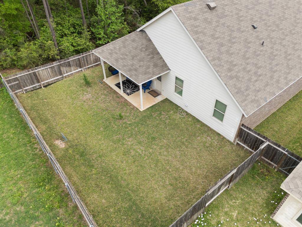 Enjoy a serene backyard retreat with lush greenery, providing peaceful privacy, with neighbors situated on only two sides.