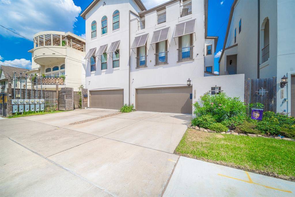 This spacious living room features gorgeous wood floors, crown molding and access to your private backyard.