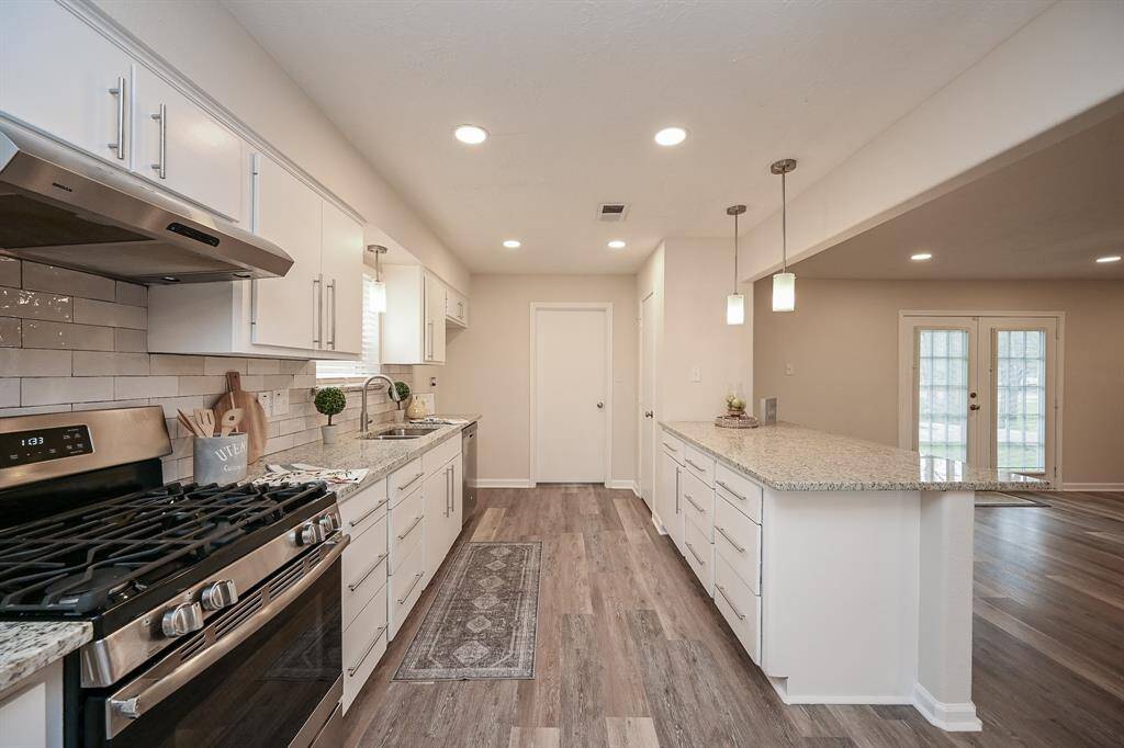 The kitchen has all new cabinets and counter tops, new backsplash, a gas range, and stainless steel appliances.