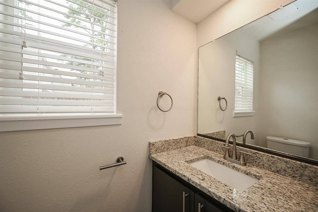 Half bath with new granite counter, new sink and faucet, and new hardware!