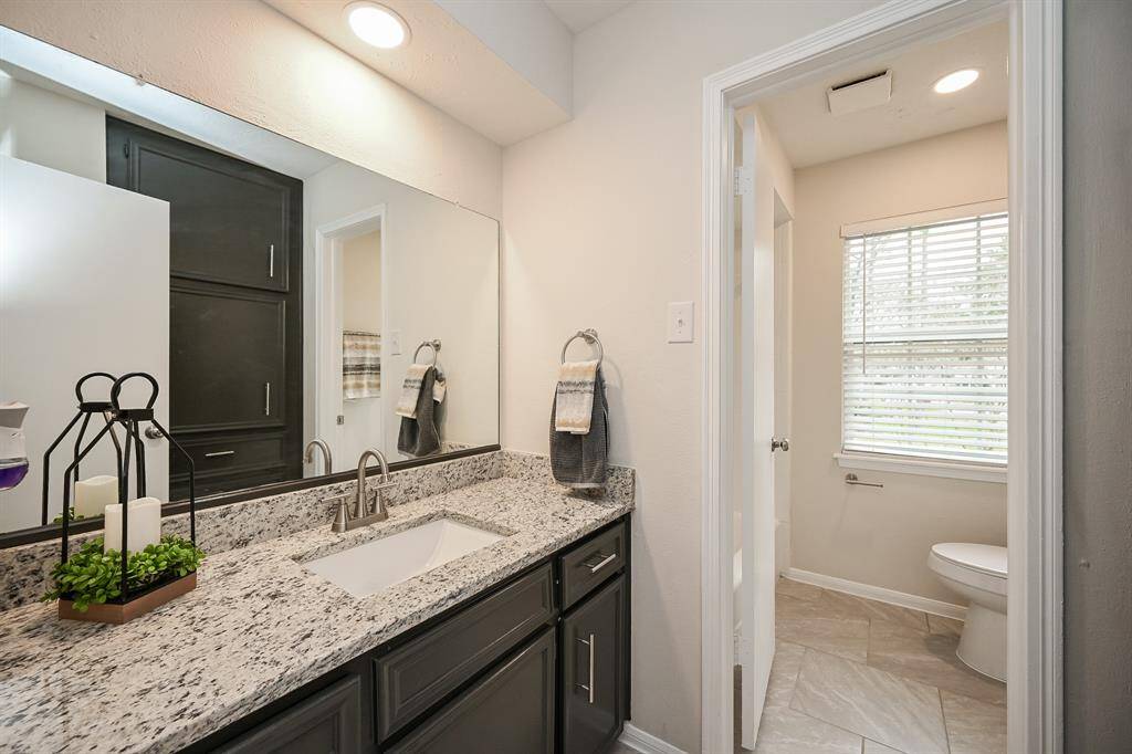 Secondary bath has all new flooring, new granite, new sink and faucet, and new hardware!