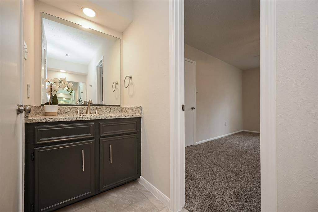 Primary bathroom has dual sinks!  This bathroom has all new flooring, new granite counters, new sink and faucet, and new hardware