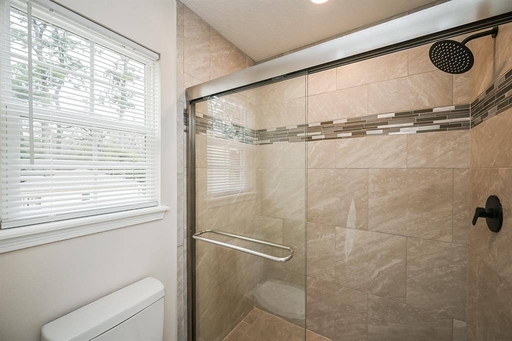 The primary bath has an all-new tiled shower and shower door!