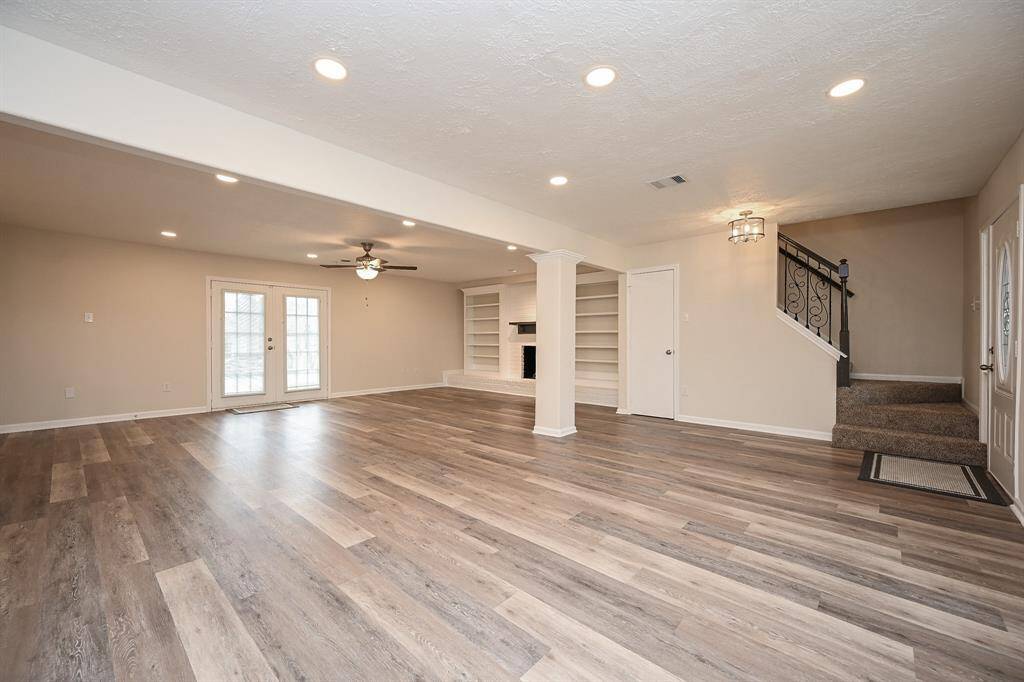 There is a French door with integrated blinds that lead out to the beautiful backyard and pool