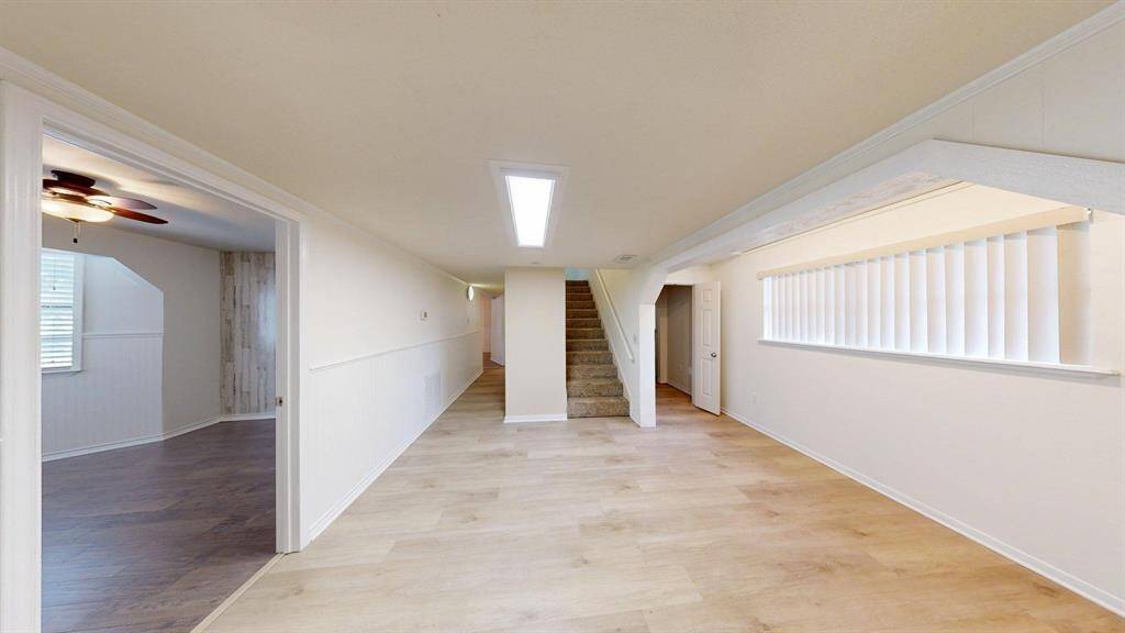 As you come in from the living room, to the left you have a large bedroom, then to the center left a hallway to the other bedroom and kitchen