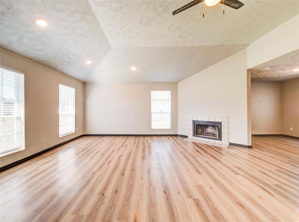 High ceilings with natural light and a fireplace