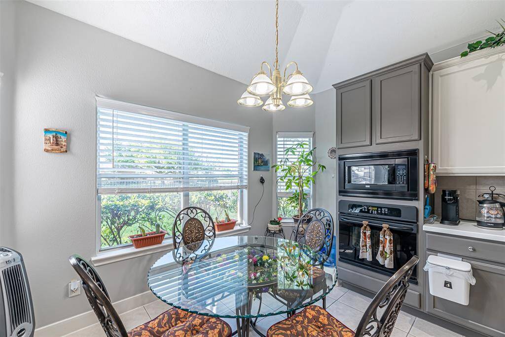 The breakfast room is just off the kitchen with tile floors and windows over looking towards the subdivision lake.