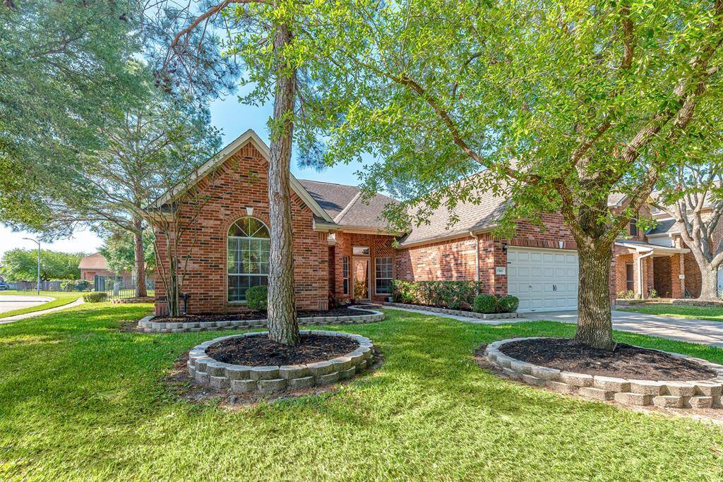 Home is located on a corner lot with subdivision lake view and mature trees.
