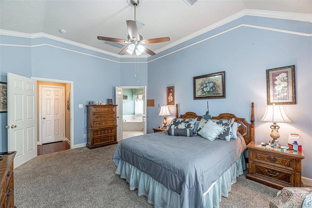 The primary bedroom is just off the family room and the double doors lead to the en suite.