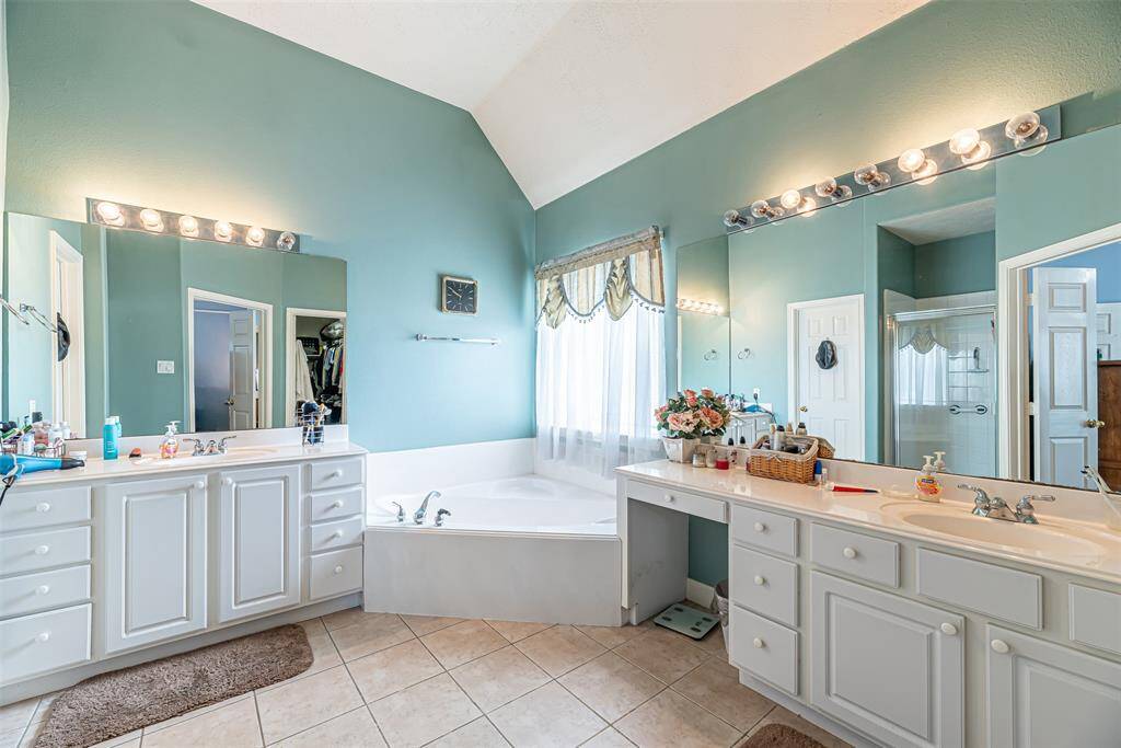 Primary bathroom has double vanities with knee space vanity area and tons of storage.