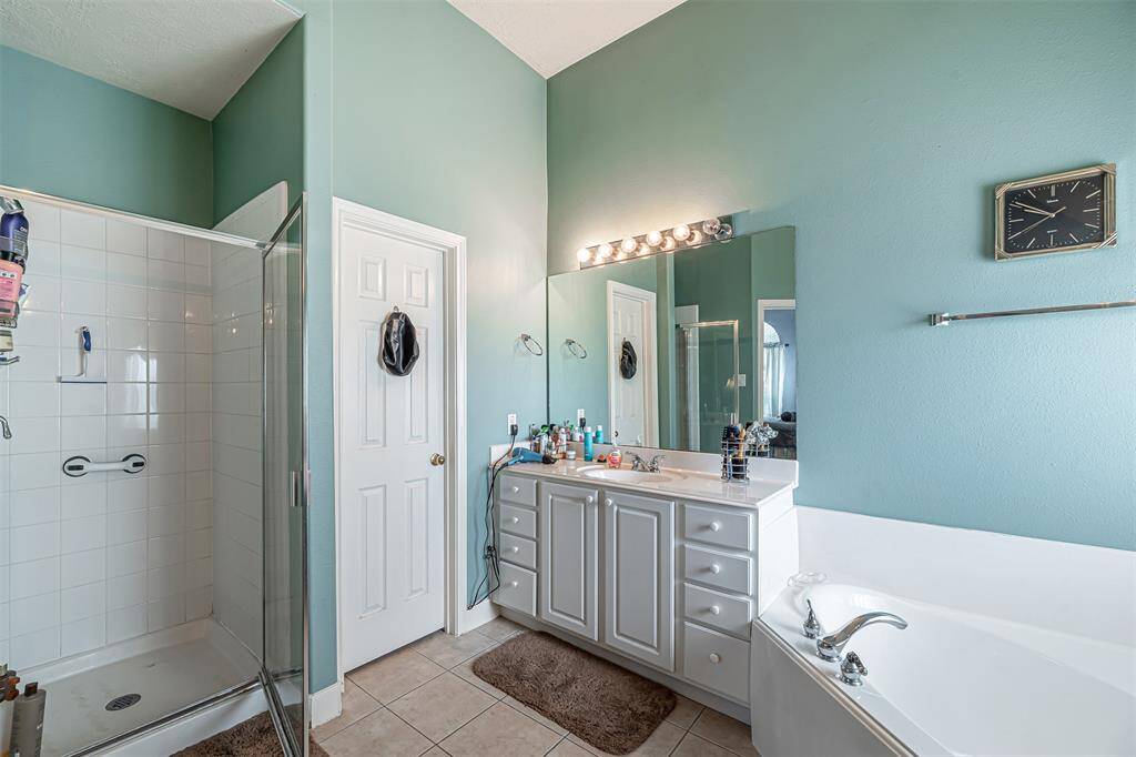 The bathroom also features a walk in shower and walk in closet.