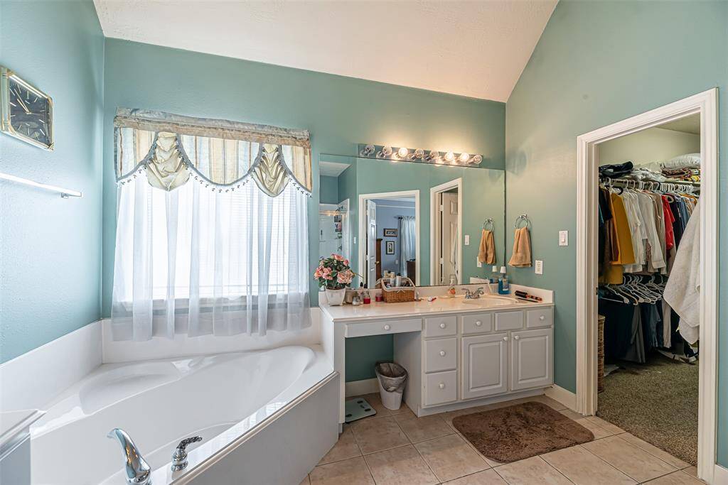 There is a separate soaking tub in the primary bathroom.