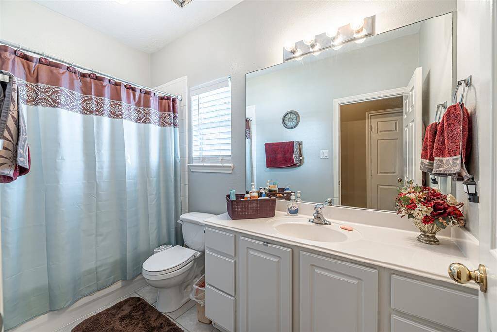 Secondary full bathroom features single sink vanity and tub/shower combo.