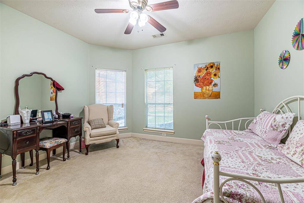 Additional secondary bedroom has carpet, ceiling fan and picture windows.