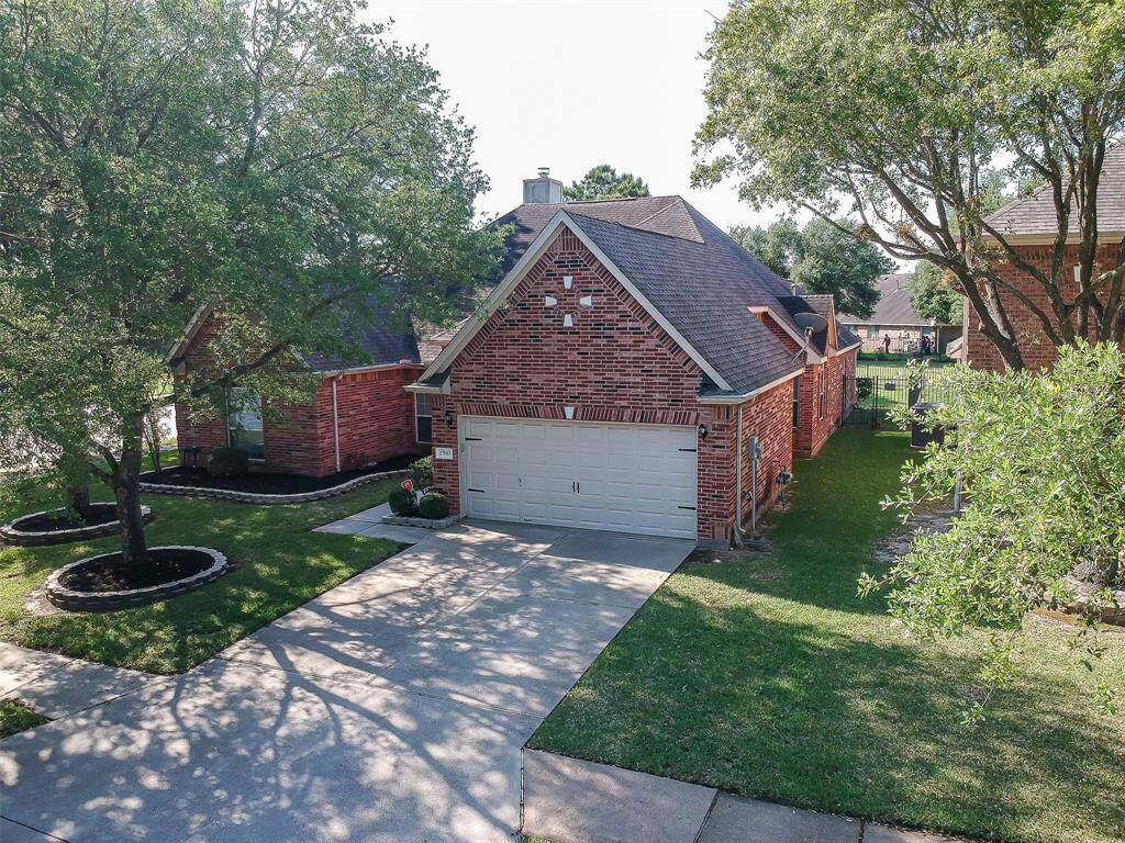 The home also features a two car attached garage and flower beds with paver surround.