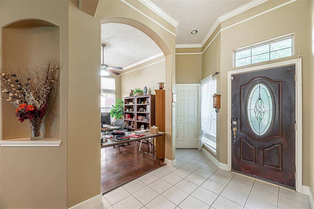 Front entry of the home has tile floors and is open to the study and family room.