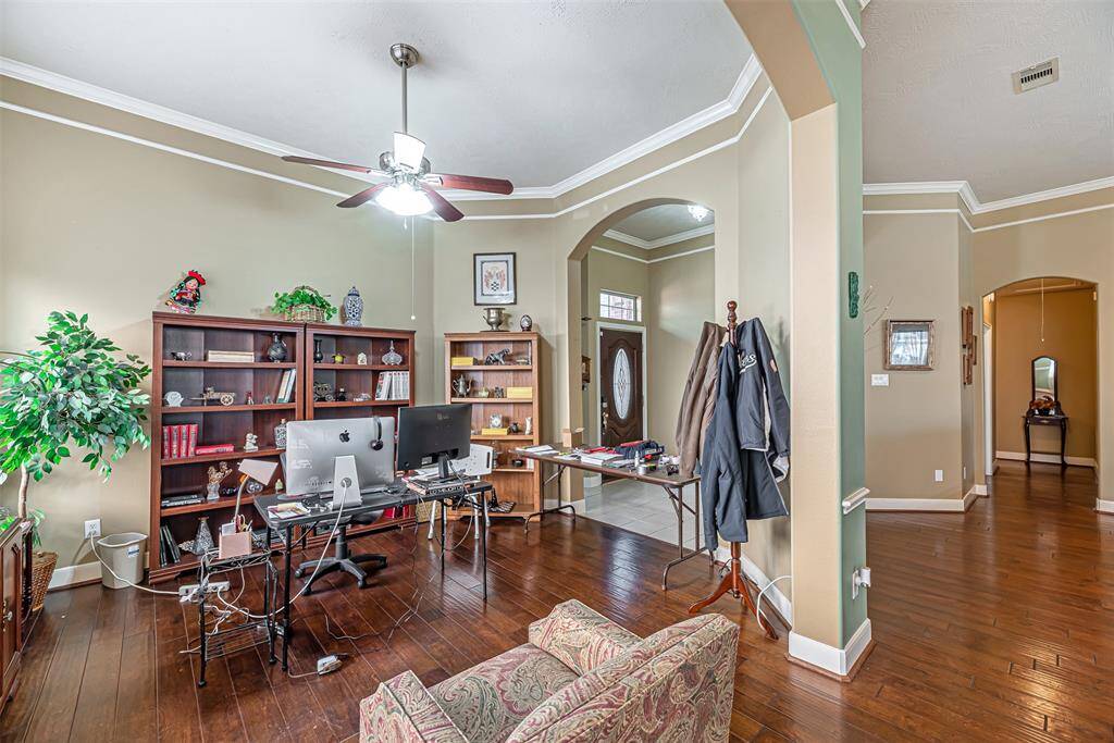 The study also has three large windows and decorative trim.