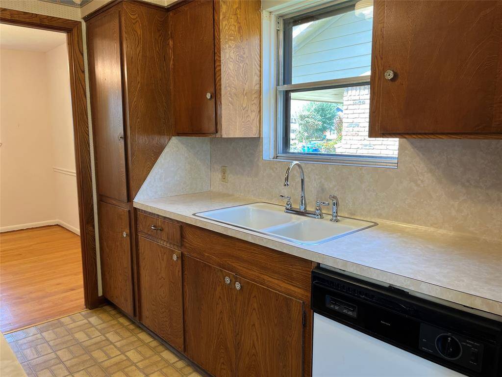 The countertops are laminate and the cabinets are solid wood. The pantry cabinets are just beside the opening to the formal dining room.