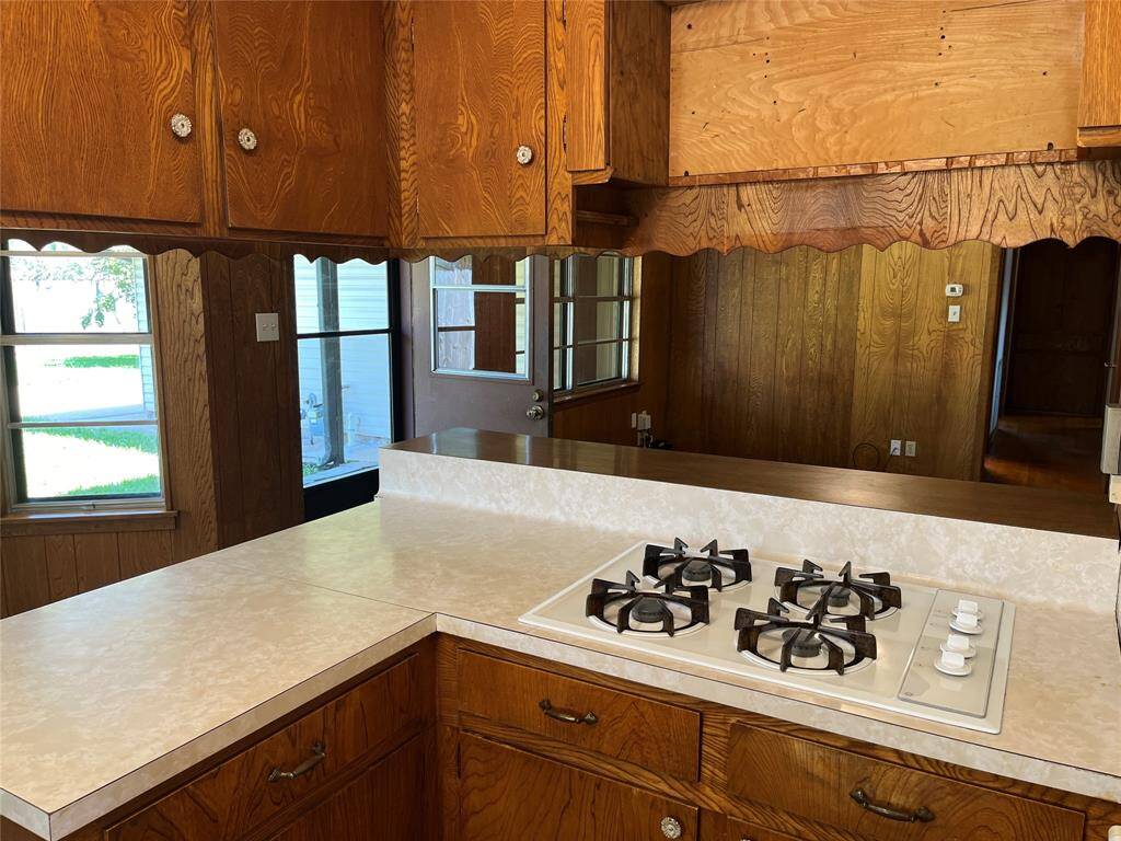 The cooktop is situated so the cook is never left out of the fun. You can see into the living room from the kitchen, and there's a breakfast bar.