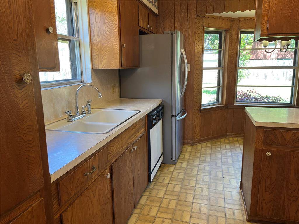 This is what the kitchen looks like as you enter from the formal dining room. The fridge stays and the faucet is new.
