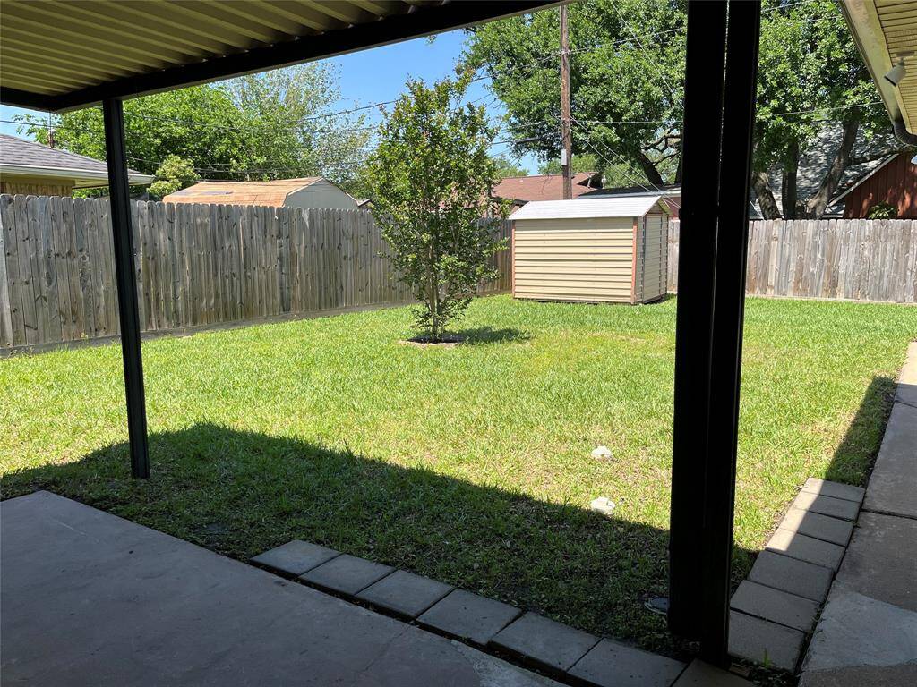 The back door is beside the breakfast nook and breakfast bar. You can see there's a covered patio in back, as well as a Morgan storage building.