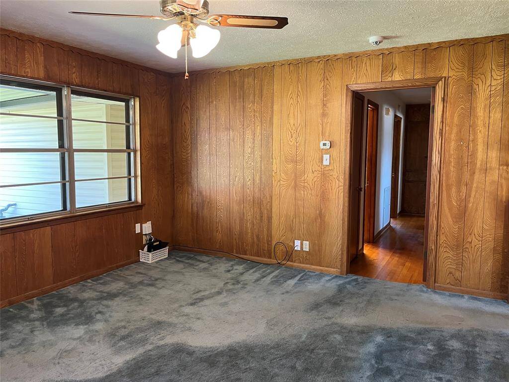 The back patio is visible through the living room windows. Your garage door is just beyond the window and that's where your laundry is located.