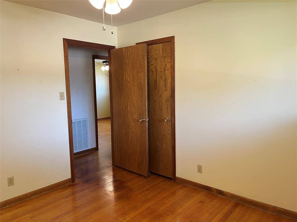 The closet is behind the entry door. We're looking into the primary bedroom across the hall.