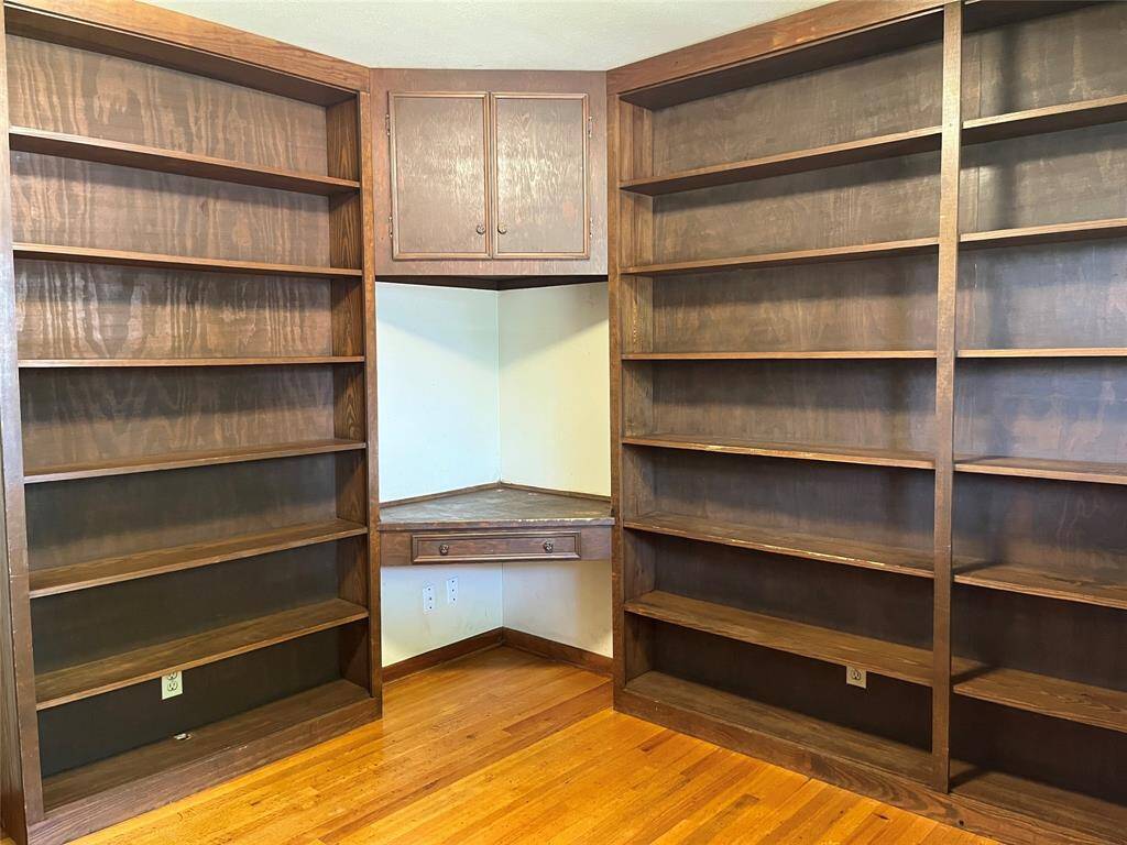 This is the other secondary bedroom along the front of the house and at the end of the hall. It was used as a library/office and has built in bookshelves and this corner desk.