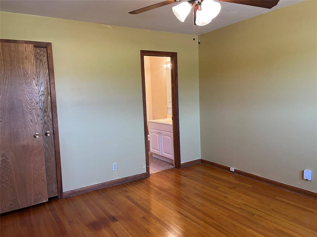 The entry door is to our right. Just behind it is a small closet, and the primary bath is through the open doorway in the middle.