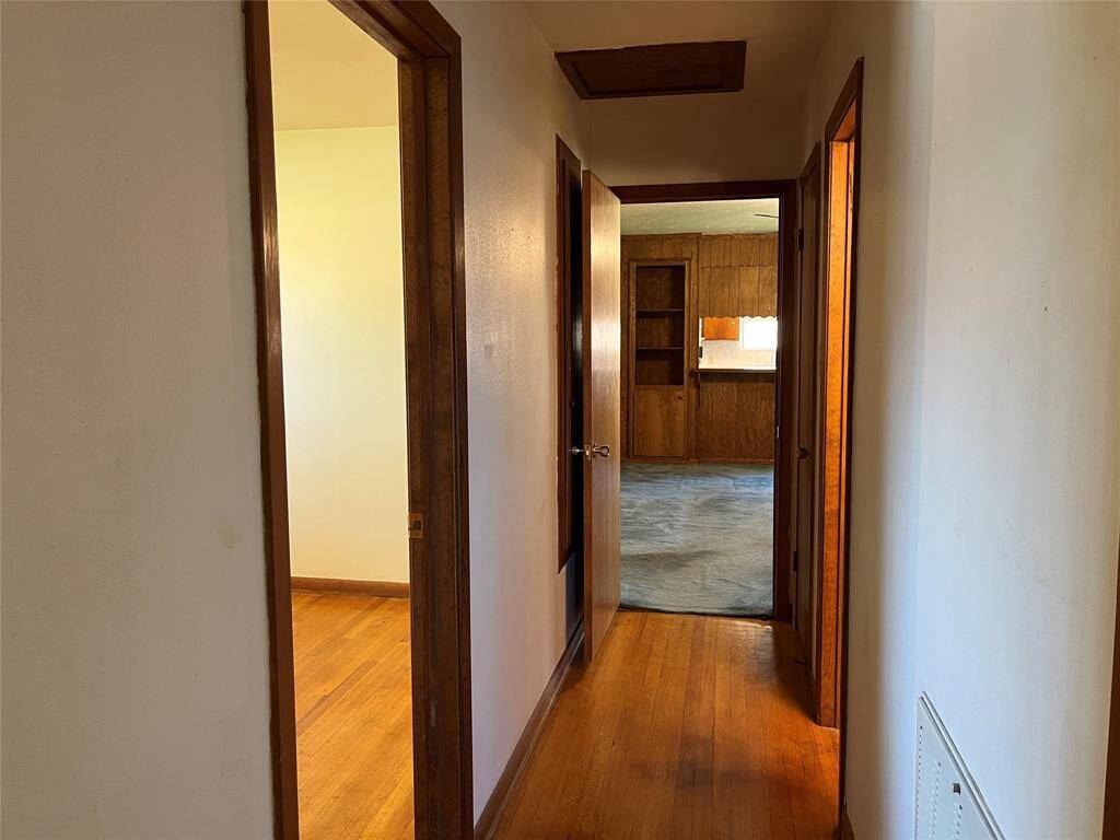 The linen closet and hamper is directly behind us. We are heading down the hallway toward the living room. Check out the hall fixture that can be a bright light or a really cool night light. Turn the switch off, then turn it back on again to see the different functions.