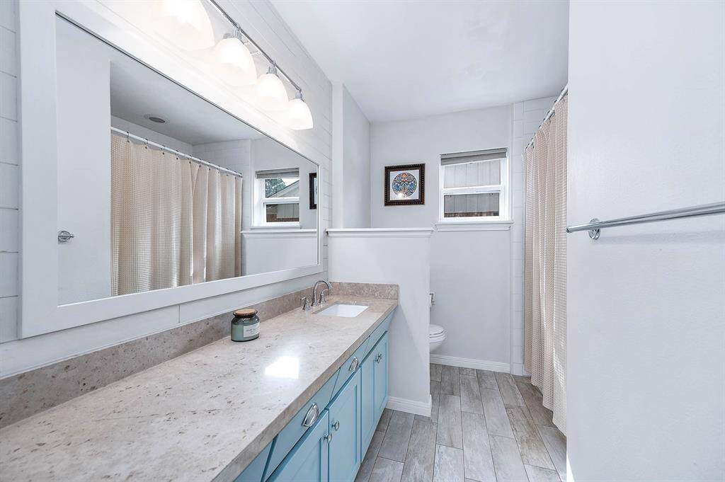 The secondary bathroom features a tub shower combo and is right at the entry of the hallway, perfect for guest access.