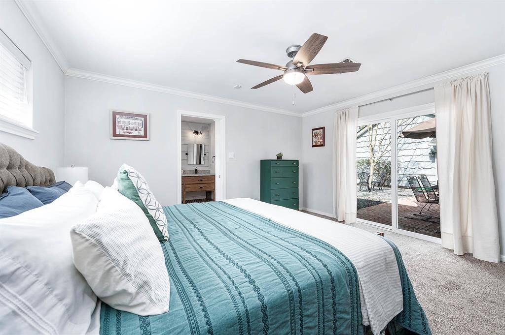 Sliding glass door off the primary bedroom offers direct access to the back patio.