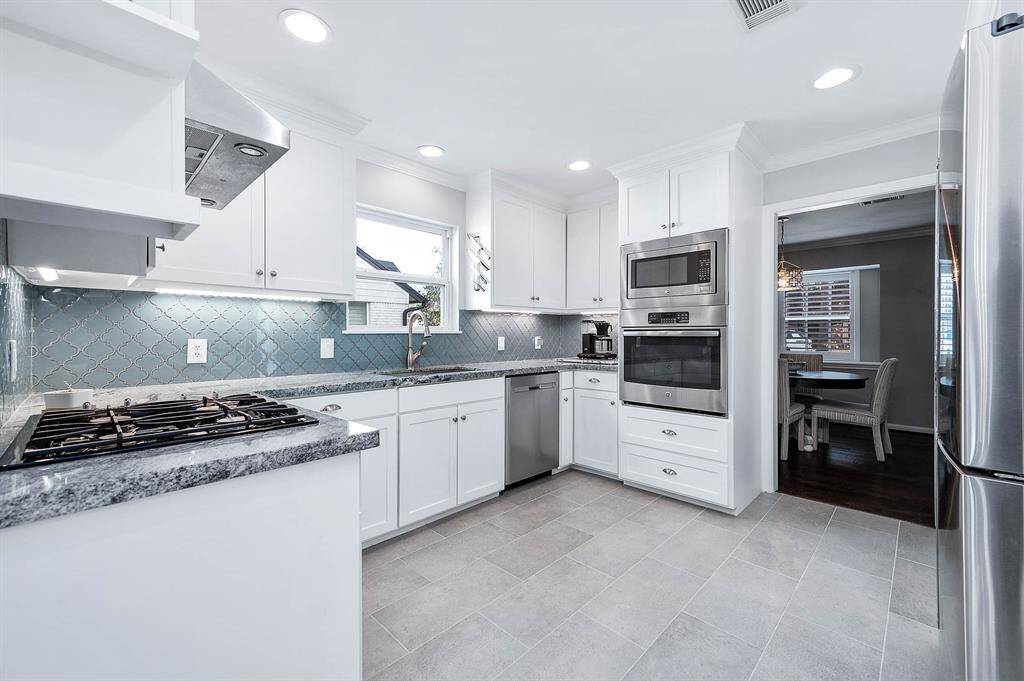 Ample cabinet space, stainless steel appliances, and a gas cooktop make this kitchen a chefs dream with pass through entrance to the formal dining room.