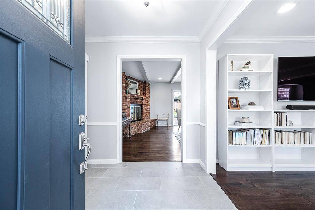 As you enter the home, off to the right is a flex room that could be used for many purposes and straight ahead is the formal living.