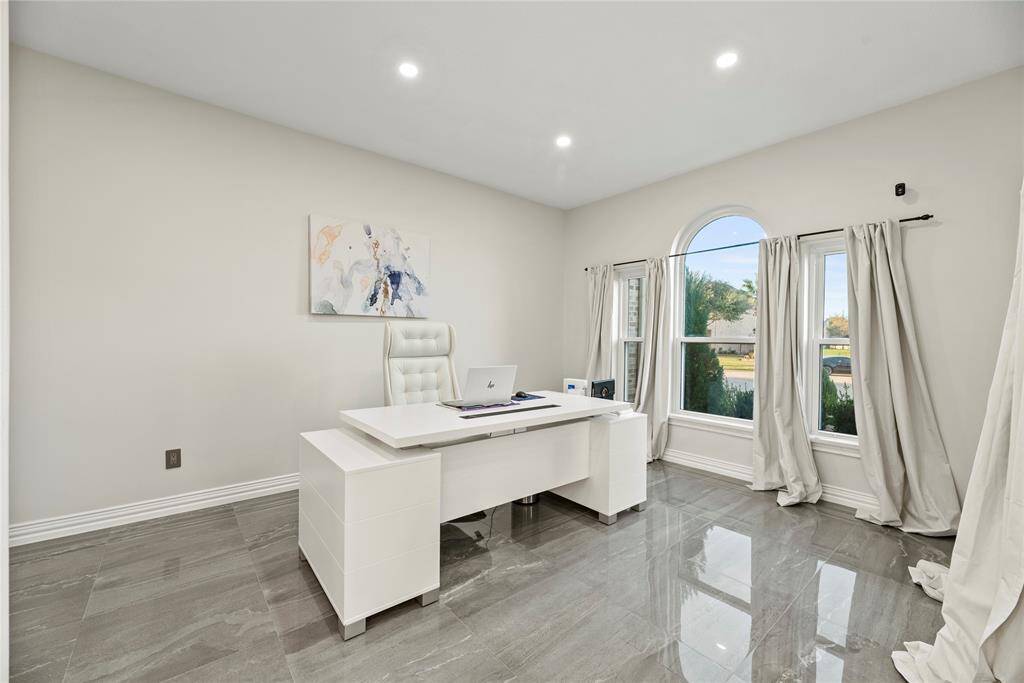 Versatile formal living space off the foyer is currently furnished as a home office.