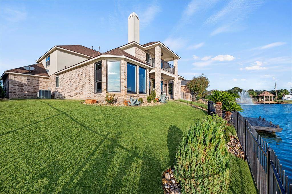 Large picture windows and multiple outdoor living spaces, perfectly positioned for enjoying stunning water views.